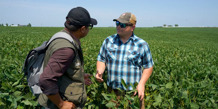 Author in conversation with young farmer Riley Schnell in Sully, Iowa.